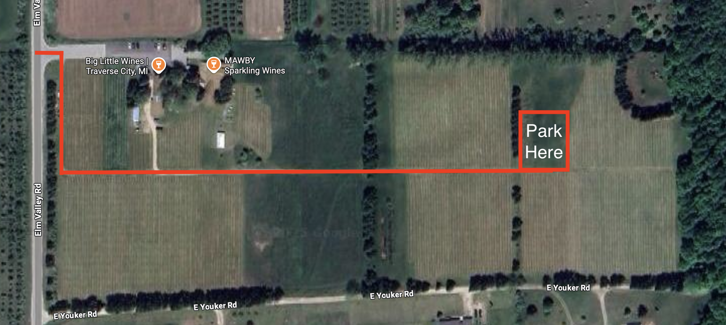 A satellite map showing vineyards near Elm Valley Road and E Youker Road in Traverse City, Michigan. A bold red line highlights a driving route from Elm Valley Road through the vineyard to a marked parking area on the east side of the property. A red box labeled “Park Here” indicates the designated parking spot. Nearby locations include Big Little Wines and MAWBY Sparkling Wines.